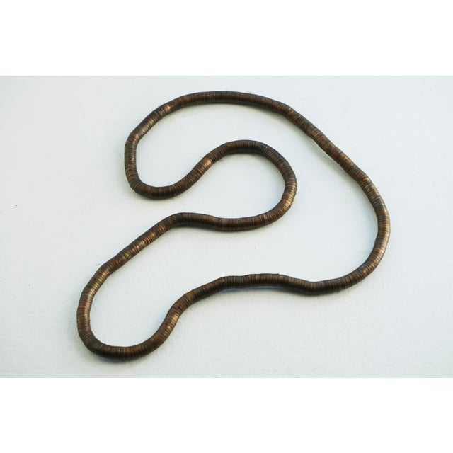 Vintage segmented metal “snake” necklace or bracelet designed to bend and hold shape. Composed of small connected...