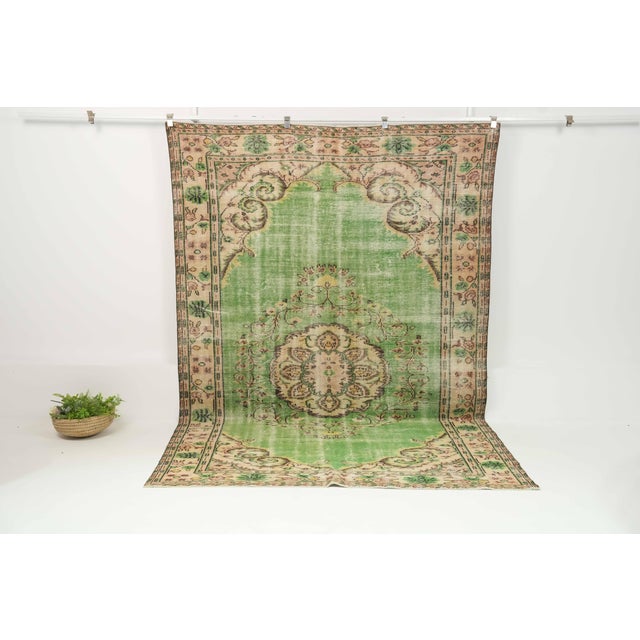 This vintage hand-knotted area rug is a semi-antique vintage area rug. The '70s Eastern Anatolian region's unique rug is...