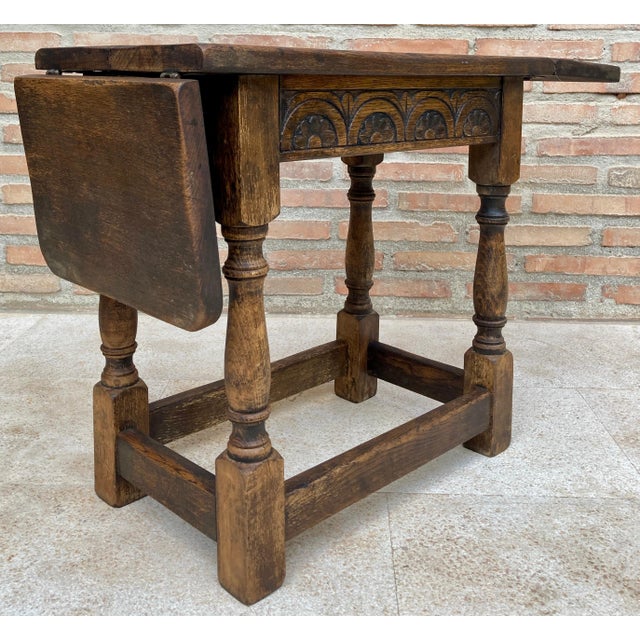 Side table with wings in walnut wood in the Spanish Castilian style. Beautiful small side table with side wings. A very...