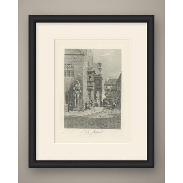 A street corner in old Halberstadt, dominated by the Gothic Town Hall and its famous statue of Roland. The armored figure,...