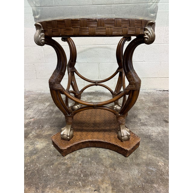 This is a fabulous center or dining table. Rattan woven metal base with ball and claw feet in brushed gold. Beveled glass...
