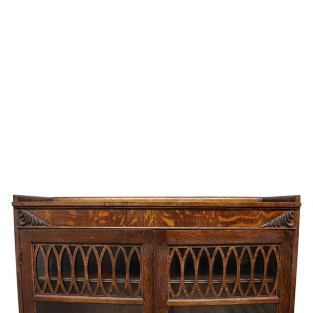 This antique Mission style Arts & Crafts bookcase, dating to approximately 1920, is crafted from oak and features its...