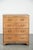 We are offering this large antique English light oak chest of drawers from the 18th century, featuring gold-colored...