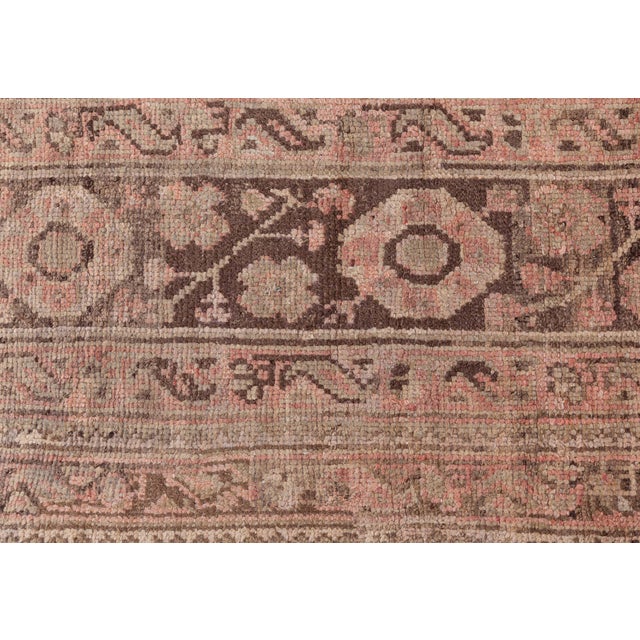 This oversized antique Turkish Oushak rug, handwoven circa 1900, is a stunning example of Anatolian textile artistry....