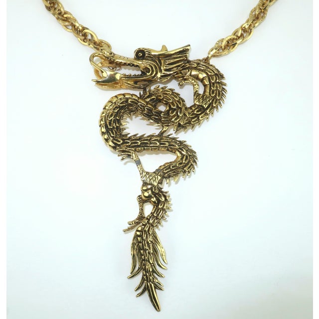 Enter the dragon! You will turn heads and garner compliments with this striking dragon necklace in an antiqued gold tone...