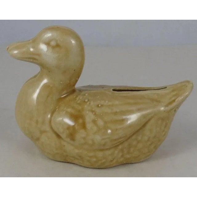 Antique French majolica yellow duck money bank, circa 1900.
