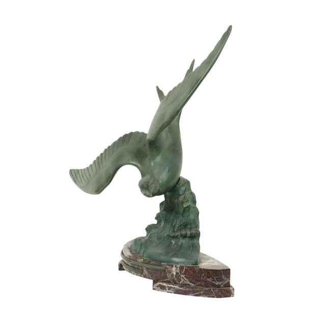 Large Art Deco sculpture, a seagull in flight, on a rounded red marble base. The sculpture is presumably made of spelter...