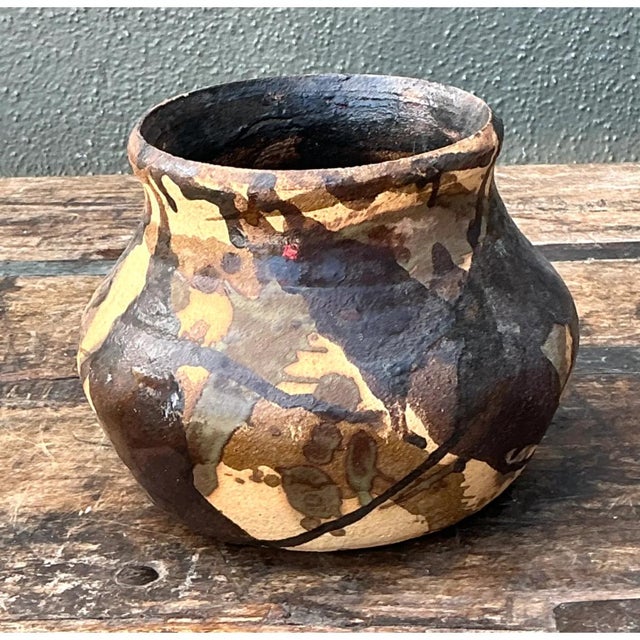 This vintage abstract ceramic vase presents a compelling, organic silhouette, its rounded, bulbous body rising from a...