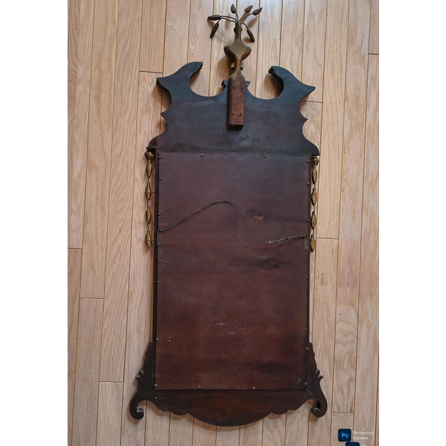 elegant tall narrow wood mirror with brass accents. chippendale shape with regency and federal details