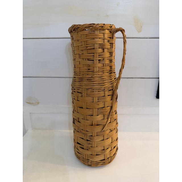 Vintage 20" tall wicker rattan floor basket with a handle. Could be used as umbrella stand, urn or vase.