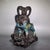 A striking Chinese Cloisonné enamel sculpture of a ram. The figure is depicted standing on a stylized bronze-colored...