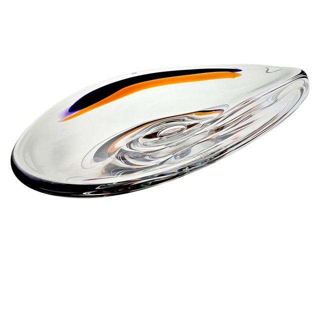 It curves like a breath—glass sculpted in stillness. Designed by Göran Wärff for Kosta Boda, this Swedish centerpiece is...