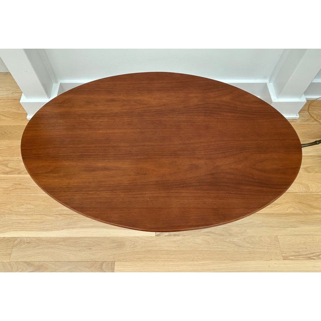 Walnut topped oval coffee table Attributed to Eero Saarinen for Knoll International. C. 1960. The label is missing, but...
