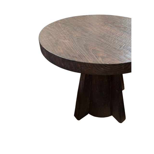 A wonderfully sculptural round side table. Crafted from solid suar wood with wood textures and shades throughout. The...