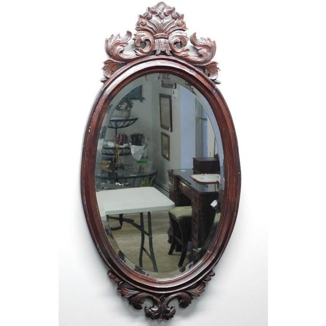 Late 19th Century Victorian Carved Mahogany Oval Beveled Wall Mirror An exceptionally fine example of Rococo Revival...
