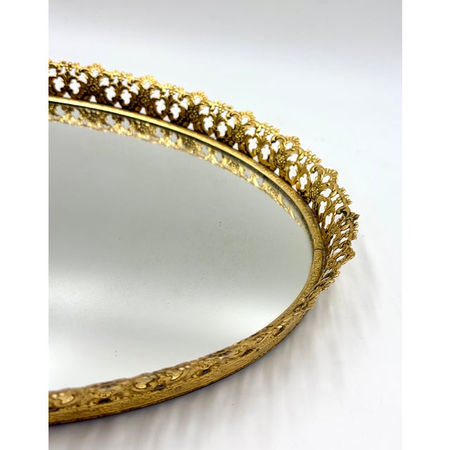 A stunning vintage French gilt gold ormolu oval mirror vanity or bar tray. This beautiful tray is a nice large oval size...
