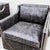 A pair of classic "Delano" club chairs with nailhead detailing in a distressed slate grey leather, made in America by...