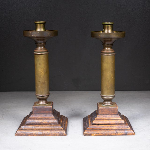 ABOUT A pair of vintage column candlestick holders. Each piece features a solid brass cylindrical column stem set upon a...