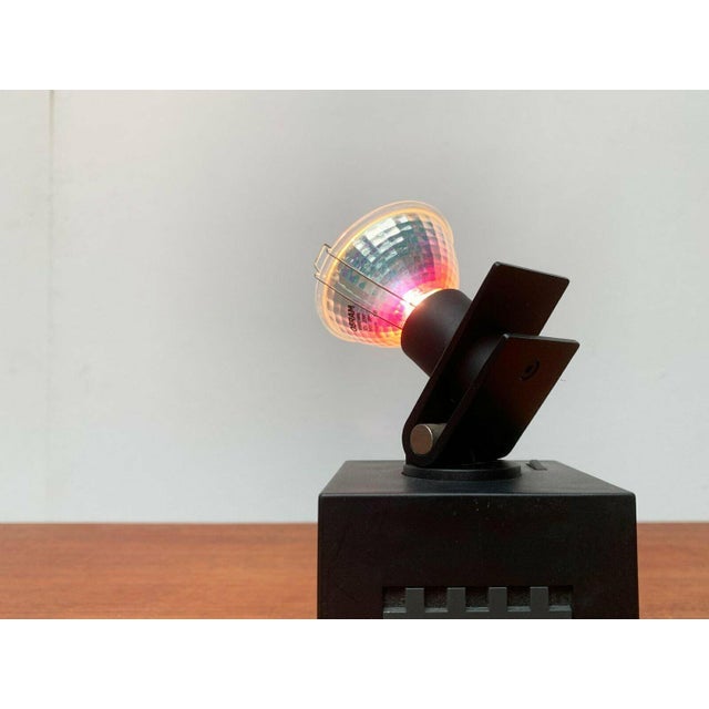 Postmodern table or wall lamp from Osram. A functional design with postmodern details. The cubic base primarily consists...