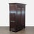 This Kerry Joyce hutch and armoire features a classic dark wood finish and elegant double doors with a textured design....