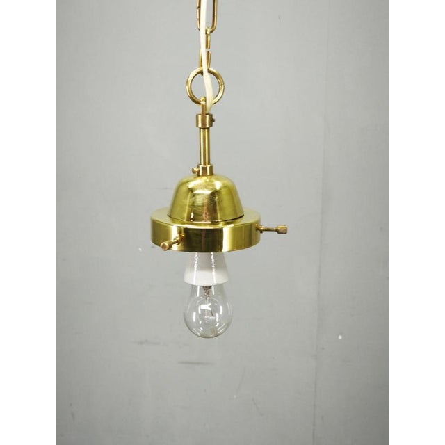 Elegant Mid-Century Modern pendant light, produced in Czechoslovakia during the 1970s. The design centers around a large...