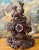 A late 19th century Swiss Black Forest hand-carved clock — the classic alpine carved case in the Brienz tradition, with...