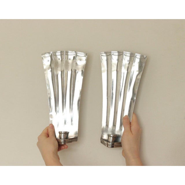 Pair of early 20th‑century Swedish hammered pewter sconces by Tage Fong‑Stedt, dated 1925. The hand‑hammered pewter...
