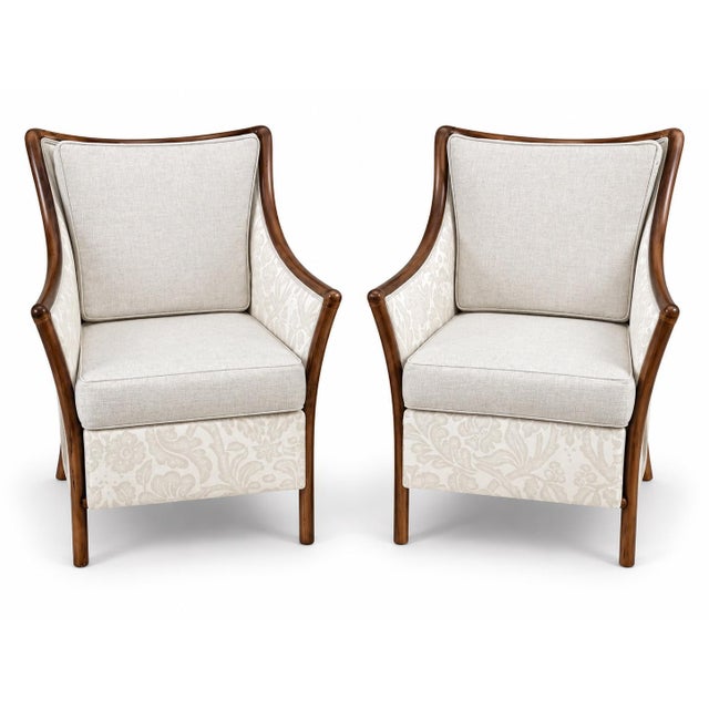A striking pair of McGuire style rattan armchairs, distinguished by their sculptural rattan frames. The rattan frames have...