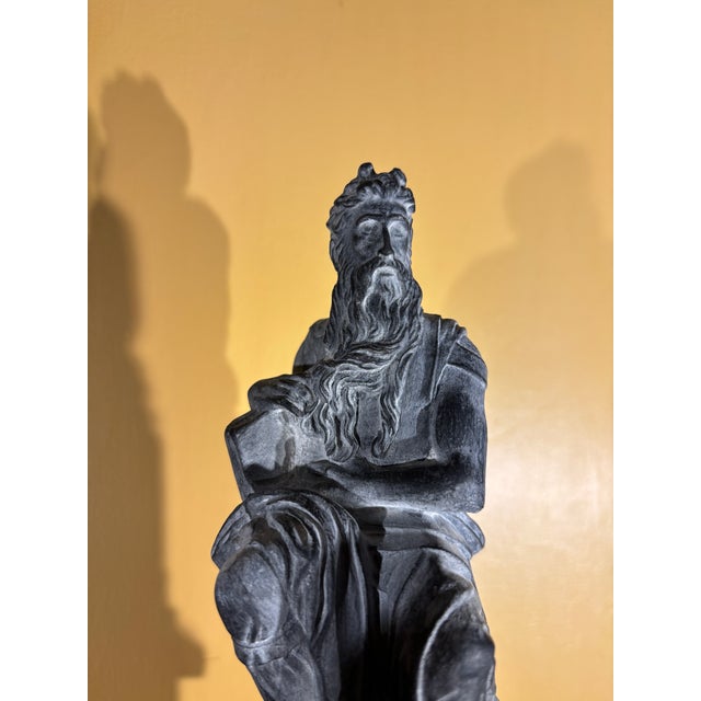 Italian grand tour style faux stone finish figure of Moses after Michelangelo. The figure is displayed on the vintage...