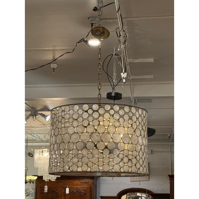 Design Plus Gallery presents Serena Capiz Shell Drum Chandelier from Oly Studio. This drum chandelier brings an outdoor,...