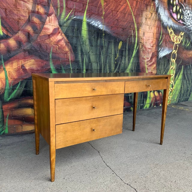 Mid century modern Paul McCobb for Planner Group Writing Desk. This maple writing desk features four pull out drawers with...