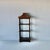 A late 20th century Chinoiserie style lacquered black wood with gilt highlight wall rack . The wall rack has three shelves...