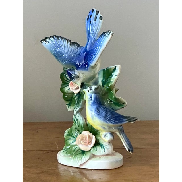 Celebrate the beauty of nature with this dynamic vintage ceramic bird figurine. This captivating piece features a stunning...