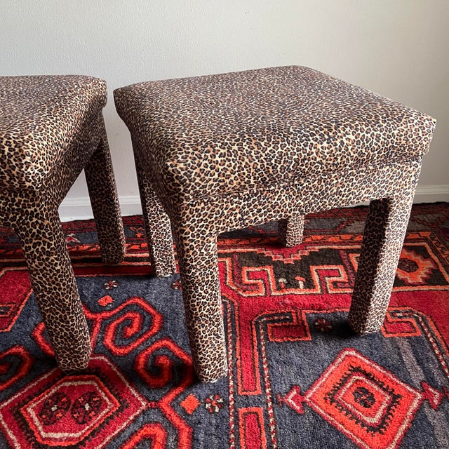 Vintage pair of upholstered stools in a leopard print fabric. Clean, simple lines with fully upholstered legs and...