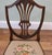Elegant mahogany side chair in the Hepplewhite style with a finely shaped shield back. The moulded back frames an openwork...