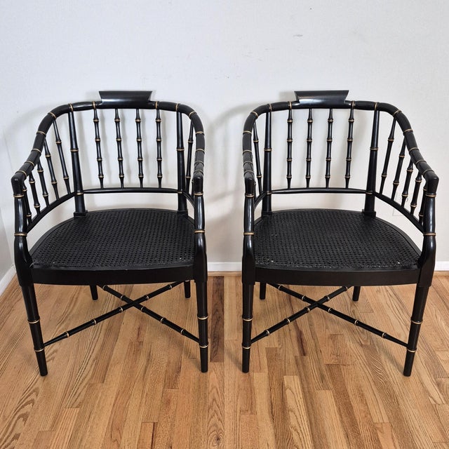 This is a glamorous pair of black and gold painted faux bamboo arm chairs. The chairs are missing the makers mark, but...