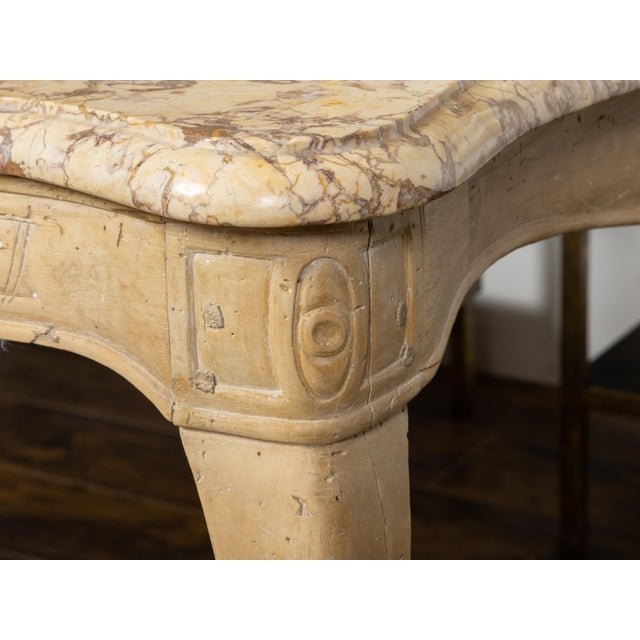 A French Rococo beech wood console table from the 18th century with variegated marble top, natural patina, serpentine...