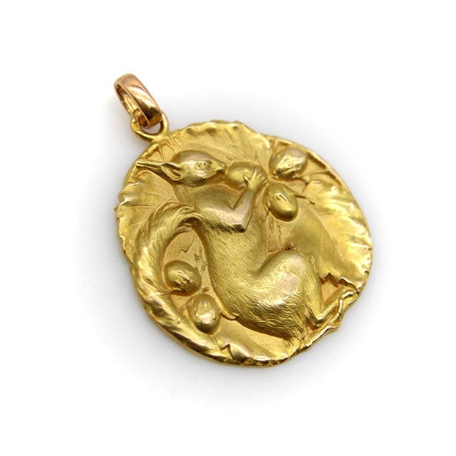 This 18k gold medallion pendant depicts a red squirrel in the exquisite detail and beautiful casting that French jewelry...