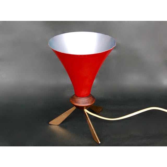 This unique table lamp was designed and produced in Italy during the elegant 50s. It features a conic shade and a...