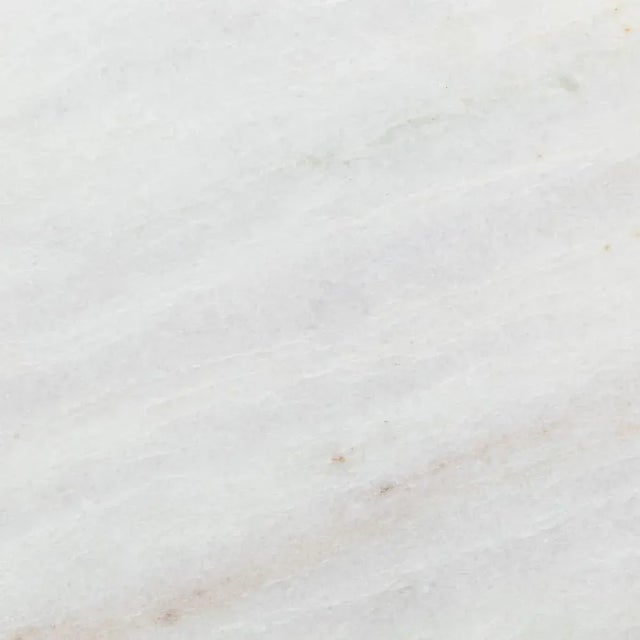 A heavy, acid-etched steel block anchors a telescoping base finished in antique brass and a gleaming white marble top....