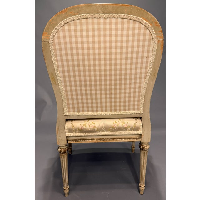 This set of four French Louis XVI style armchairs, circa 1890, features original polychrome and parcel gilt finishes with...