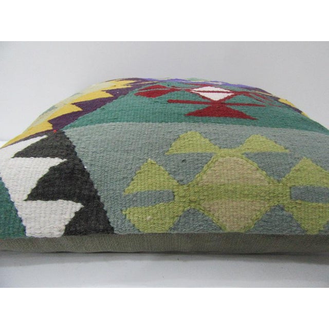This is a pillow cover made from a vintage kilim rug. The piece was properly washed and ready to use. Pillow inserts not...