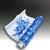A rare Japanese Seto porcelain scholar's brush holder formed as a scroll and decorated in underglaze blue and white....