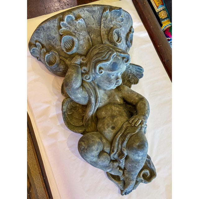 Wall hanging concrete cherub planter. Height 21.25" Width 15.25" Depth 6.5" Planter depth 5.5" Planter width 13"