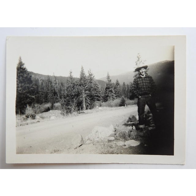 Early 20th century snapshot photograph of handsome man at a mountain road. Unframed.