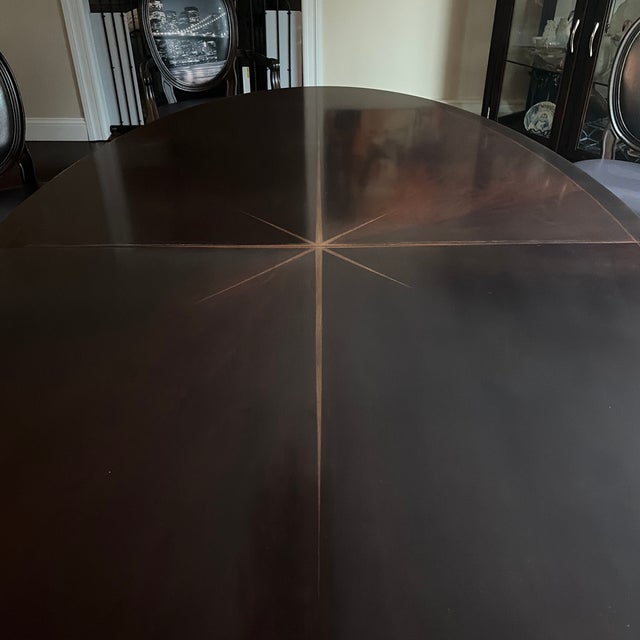 A gorgeous Celestial Sunburst Oval dining table by Barbara Barry for Henredon.The Sunburst wood grain pattern and delicate...