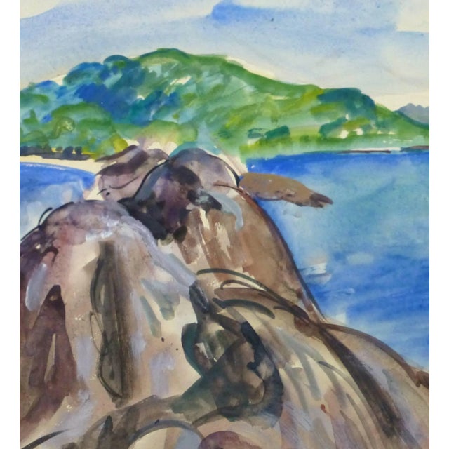 Striking watercolor seascape of a rocky inlet circling an island lush with dense foliage by French artist Stephane...