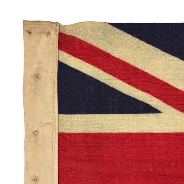 This vintage Blue Ensign flag is made from a wool cloth in dark navy blue, with printed design visible on both sides....