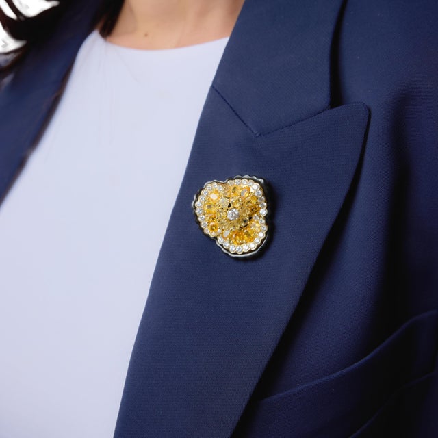 This extraordinary Lugano flower brooch is a bold and luxurious expression of modern high jewelry design, showcasing a...