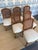Set of 6 French Louis XV style dining chairs with carved wood frames and cane backs. Newly upholstered seats in a neutral...